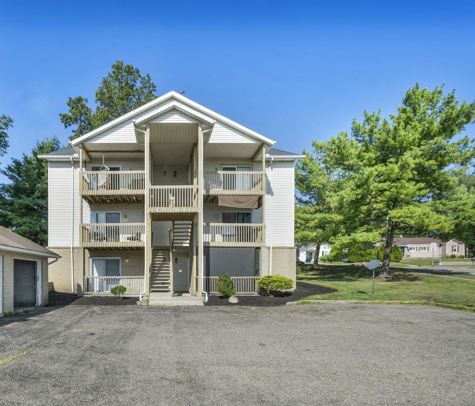 Garden-style apartment building with balconies and landscaping